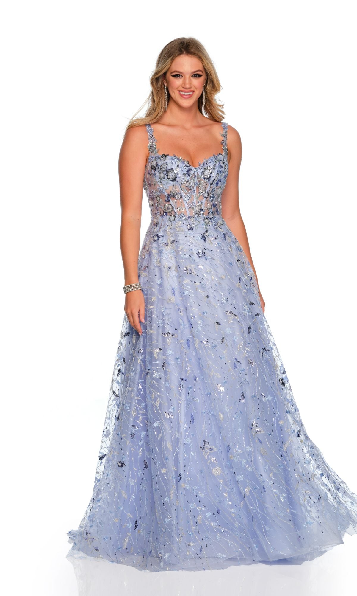 A woman wearing the Long Formal Dress 11502 by Dave and Johnny, a pastel blue gown with thin straps and floral embroidery, smiles while standing against a plain white background.